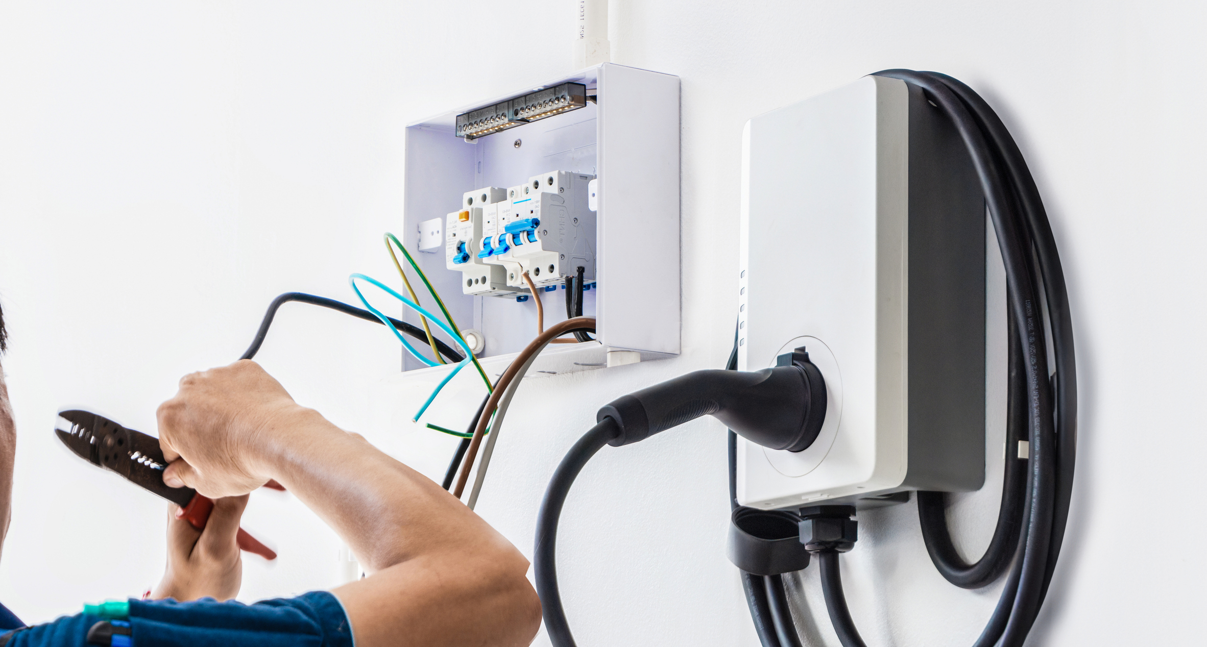 Electrician installing a residential electric vehicle charger in a Michigan home