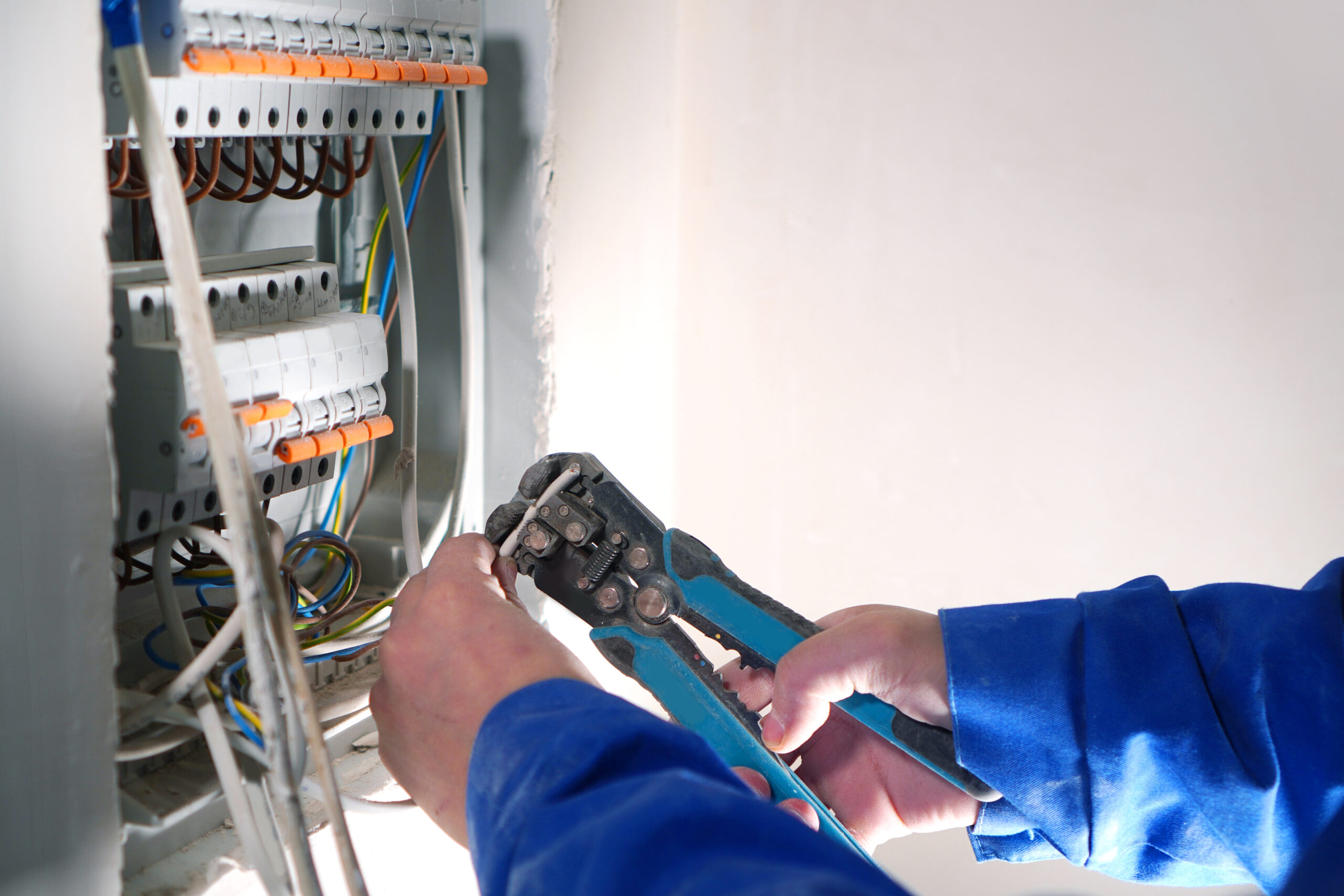 Electrician working on a home’s electrical panel